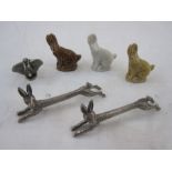 A pair of silver plated hare knife rests, three Wade china hares and a metal figure of Dumbo