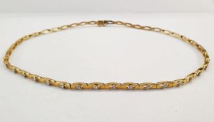 18K gold and diamond necklace set 28 small stones, each on individual openwork link, gross weight