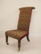 19th century prie dieu chair with needlework upholstered seat and back, turned front legs to brass