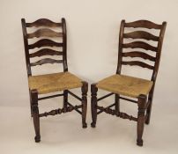 Set of eight early 20th century ladderback country chairs with rush seating, on turned front legs