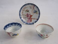 Chinese porcelain teabowl and saucer with polychrome painted figures in a garden and beside window