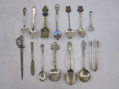 Assortment of silver and white metal spoons, sugar tongs and souvenir ware