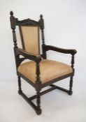 Victorian oak-framed armchair, the carved top rail on fluted arms, turned and block supports,