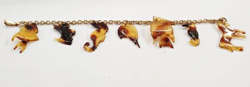 Gold belcher-link bracelet marked 12K and hung with seven assorted tortoiseshell charms including