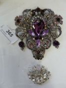 Large costume brooch with amethyst and grey-coloured stones and another oval diamante brooch with