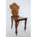 19th century mahogany shield-shaped back hall chair on turned supports, peg feet