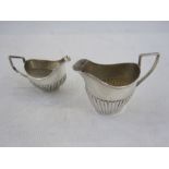 Two silver small half gadrooned cream jugs of helmet form, differing dates and makers, 3oz (2)