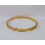 9ct gold slave bangle panelled with key-pattern engraving, 16.2gCondition ReportApprox inside length