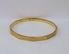 9ct gold slave bangle panelled with key-pattern engraving, 16.2gCondition ReportApprox inside length