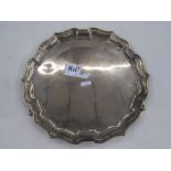 Silver salver by Joseph Gloster Limited, Birmingham 1935 of shaped circular form, on three paw feet,