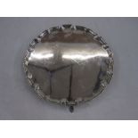 Plain silver salver with piecrust rim and on four scroll feet, London, Edward Barnard and Sons Ld,