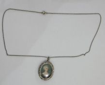 Antique gold and diamond miniature set locket, the centre inset with miniature on ivory, head and