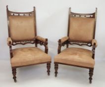 Pair of late Victorian oak-framed armchairs with upholstered seats, arms and backs, on turned