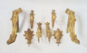 Gilt metal wall fittings, four pairs, all slightly different, decorated with leaves and acanthus
