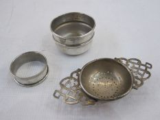 Silver tea strainer with pierced handles, a silver  napkin ring and a small silver bowl, varying