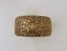 Gilt-metal wide bangle, allover foliate scroll relief decorated  Condition Report272 grms weight