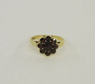 15ct gold and garnet flower shaped ring, 3g approx.