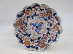 Japanese imari plaque, circular with scalloped edge and floral and foliate decoration in typical
