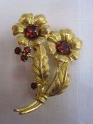 9ct gold and garnet floral brooch having two foliate sprays, each set with central claw garnet and