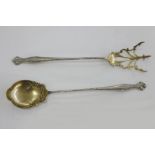 Pair of American late 19th century sterling silver-gilt serving spoons, the fork with scroll