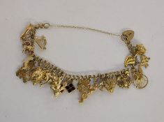 9ct gold charm bracelet with assorted charms, 38g approx. in total Condition ReportAppears to be