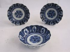 Set of three Chinese porcelain bowls, each slightly lobed and with ogee moulded border, painted in