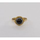 Gold-coloured metal and black banded onyx ring, set circular stone within rope borders