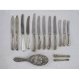 Miscellaneous silver pistol and other handled knives and a silver-backed hairbrush embossed