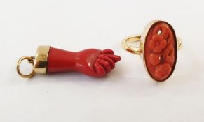 18ct gold and carved coral ring, oval floral design, openwork and a carved coral ‘hand’ pendant in