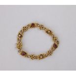 15ct gold, pearl and ruby-coloured stone ornate bracelet, trellis and scroll links set with three