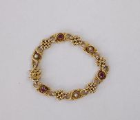 15ct gold, pearl and ruby-coloured stone ornate bracelet, trellis and scroll links set with three