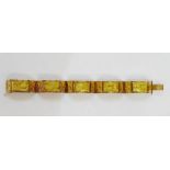 Egyptian-style gold-coloured metal bracelet panelled with relief scenes of sailing boats and camels,