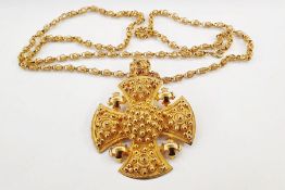 Gold fancy link chain marked 750 with a gold cross pendant with wirework and ball decoration,