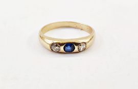 Gold-coloured, sapphire and diamond ring set central sapphire flanked by two old cut diamonds, in