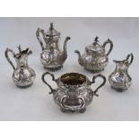 Late Victorian silver tea and coffee service of five pieces, crested and decorated with embossed C-