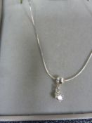 Solitaire diamond drop pendant, claw-set in silver mount, on fine chain, the stone approx 0.10ct