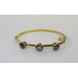 9ct gold and amethyst bangle set three claw set amethyst stonesCondition ReportApprox length 15.5cm