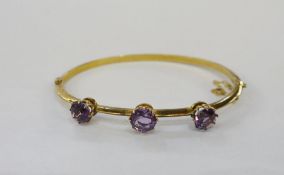 9ct gold and amethyst bangle set three claw set amethyst stonesCondition ReportApprox length 15.5cm