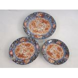 Set of three Japanese imari porcelain dishes, oval and graduated, each centred by a kylin in iron-