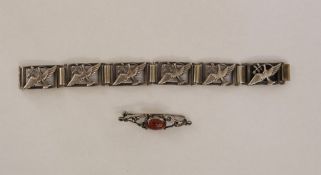 Silver-coloured metal dove of peace panelled bracelet and a silver-coloured metal and amber bar