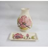 Moorcroft pottery vase, baluster-shaped with slip trails magnolia decoration on a cream ground, 20cm