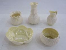 Five Belleek items to include shell-shaped dish, 13cm wide x 5cm high, a sack-shaped vase, 7cm high,