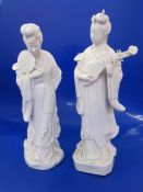Two blanc de chine porcelain figures of courtesans, one with a fan and the other with stringed