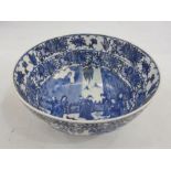 Probably Japanese porcelain bowl painted in blue and black, with group of figures in interior,