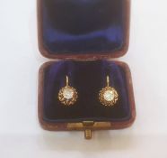 Continental gold-coloured metal and diamond earrings, the circular old cut stone in ornate pierced