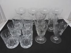 A collection of cut glasses, to include four champagne coupes, six whiskey tumblers and four crystal