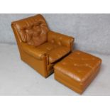 A vintage brown leather upholstered button back armchair with matching footstool. H.85 W.90 D.90cm