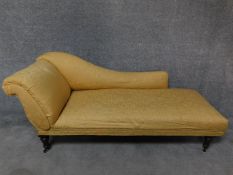A 19th century chaise longue in lemon upholstery on mahogany turned tapering supports. H.77 W.190