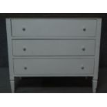 A white painted Continental style three drawer commode with limed oak top. H.89 W.106 D.49cm