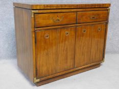An American walnut brass bound serving cabinet with fold out top, on casters. H.84 W.102 D.49cm